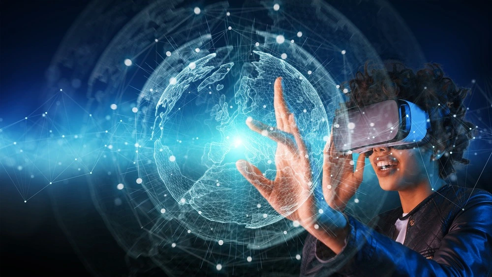 A person wearing virtual reality goggles interacts with a digital interface. A glowing, networked globe hologram floats in the background, symbolizing global connectivity.