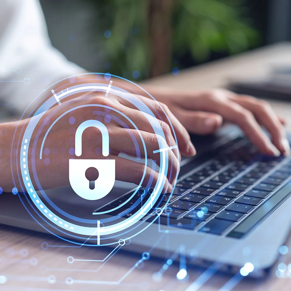 Hands typing on a laptop keyboard with a digital padlock icon overlaid, symbolizing cybersecurity or data protection. 