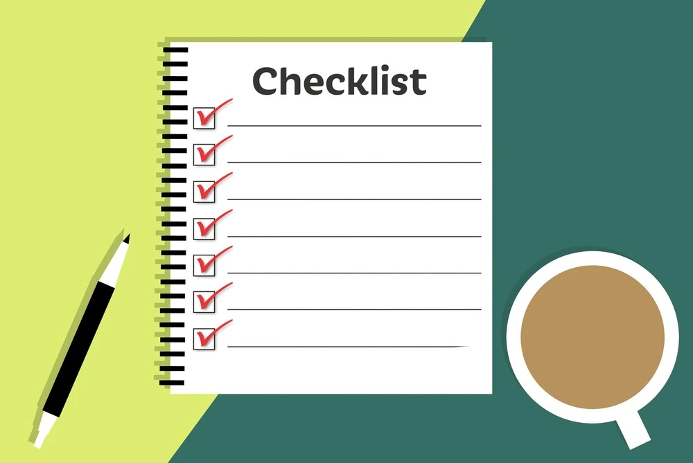 Illustration of a checklist on a spiral-bound pad, with red checkmarks next to each line.