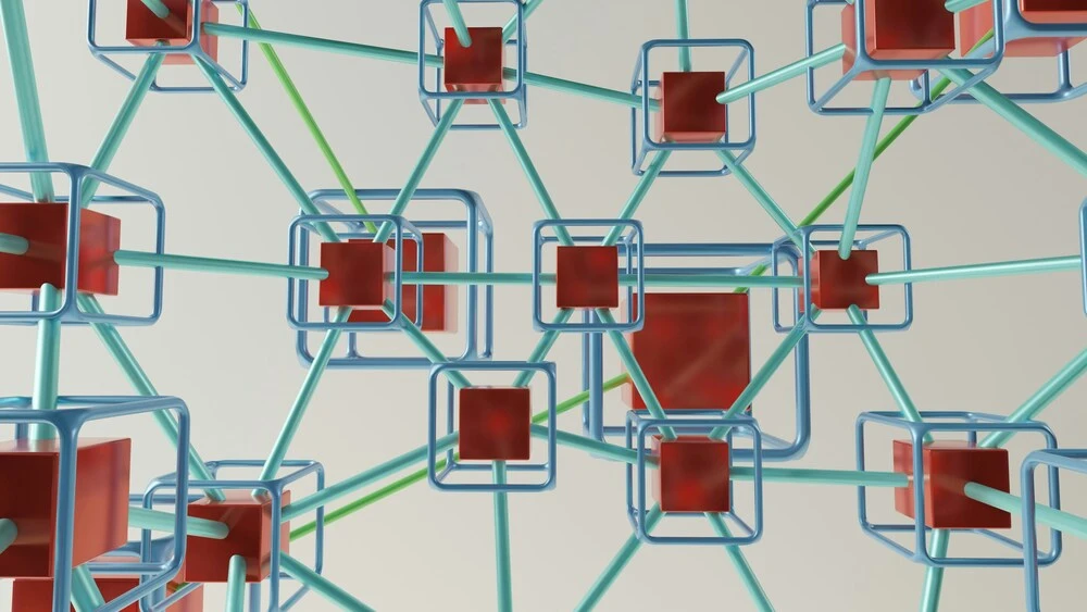 Abstract image of interconnected 3D structures with blue frames and red cubes. 