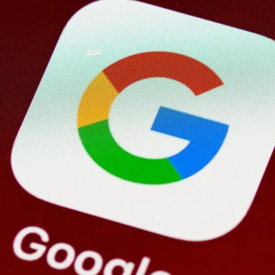 Close-up of the Google app icon on a smartphone screen, featuring the letter "G" with blue, red, yellow, and green segments against a white background.