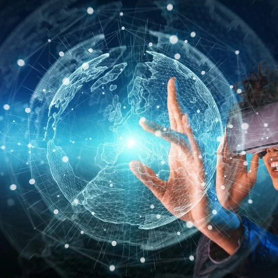 A person wearing virtual reality goggles interacts with a digital interface. A glowing, networked globe hologram floats in the background, symbolizing global connectivity.