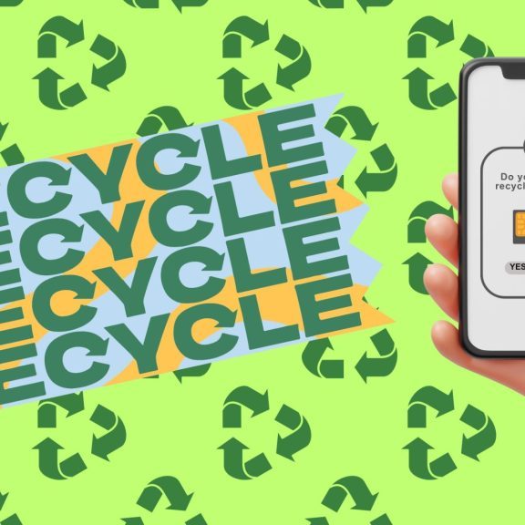 A hand holds a smartphone displaying a prompt for recycling options.
